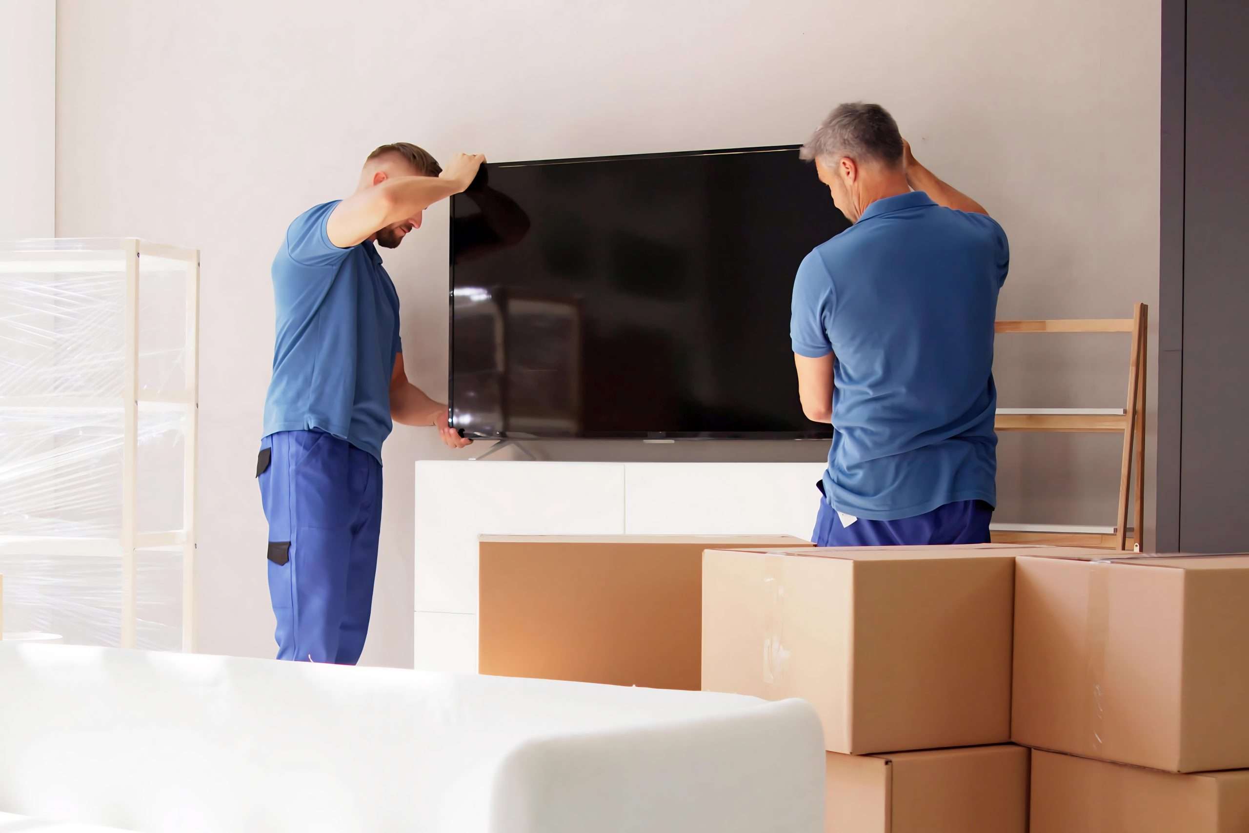 Lake Jackson movers placing a TV on an entertainment center