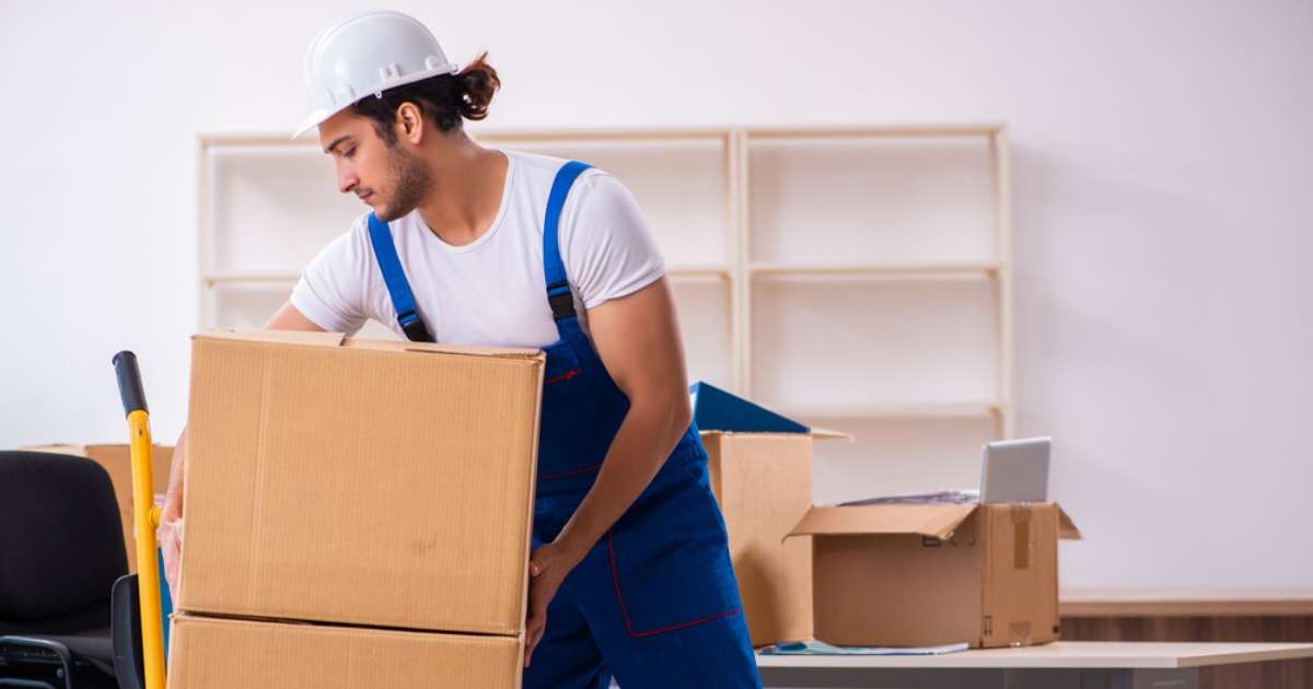 A mover with a professional Oatfield moving company loading boxes onto a dolly