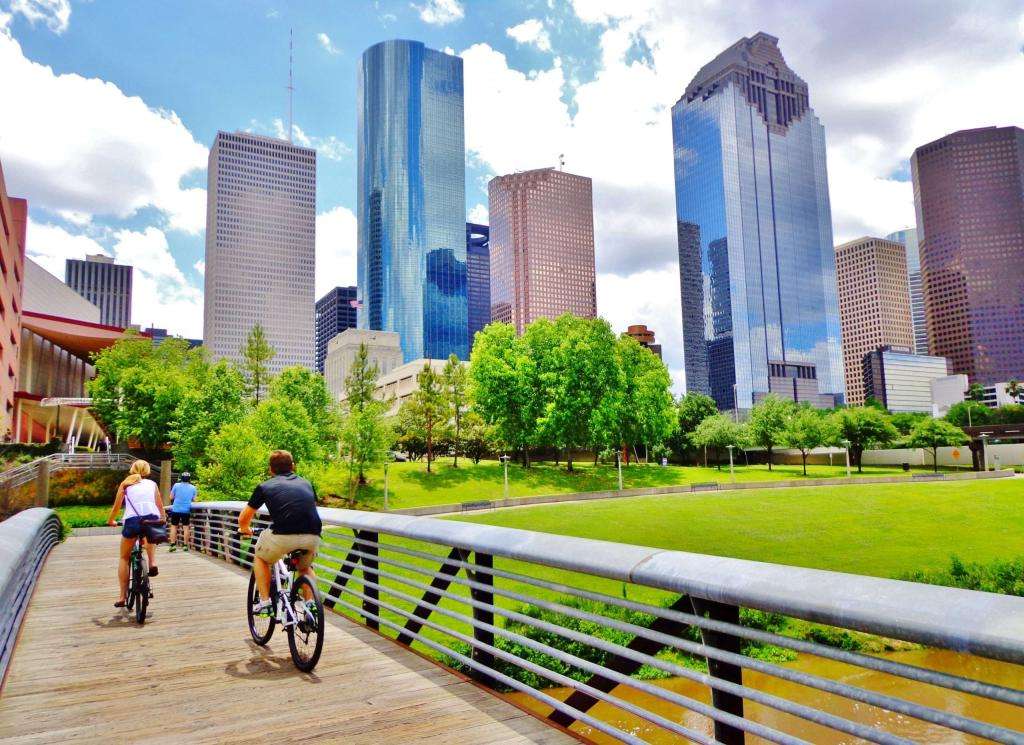 Bicyclists riding across a bridge in Downtown Houston