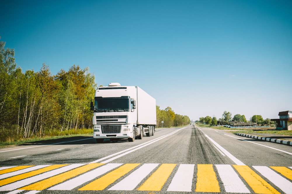 A large moving truck leaving the highway
