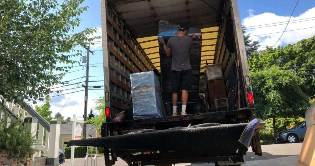 A PDX mover arranging items in the back of a moving truck