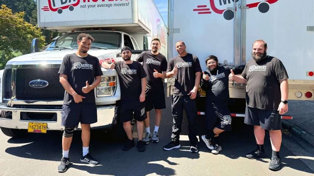 The PDX moving crew posing in front of the moving trucks during a Tualatin move