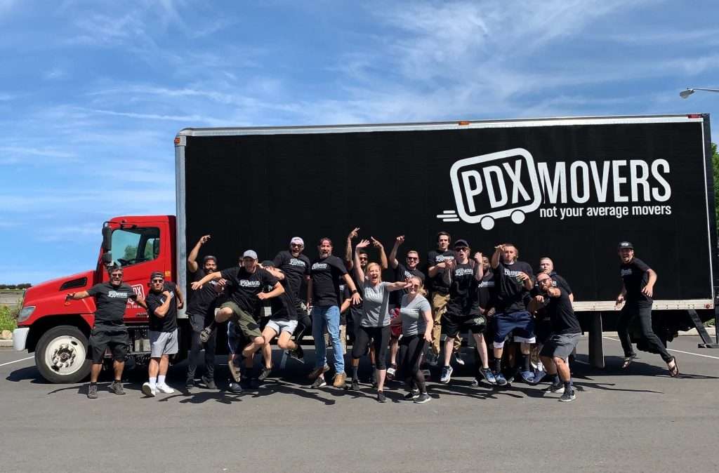 PDX Movers team jumping in front of company truck